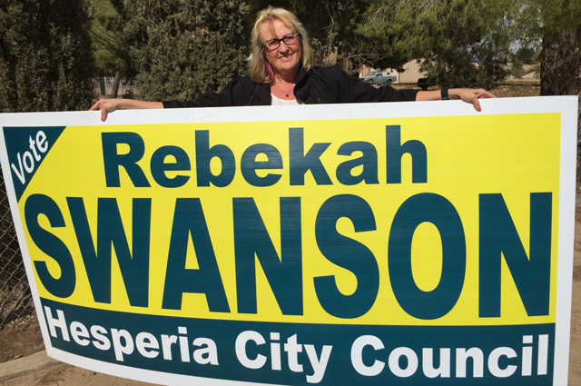 Rebekah Swanson holding campaign sign